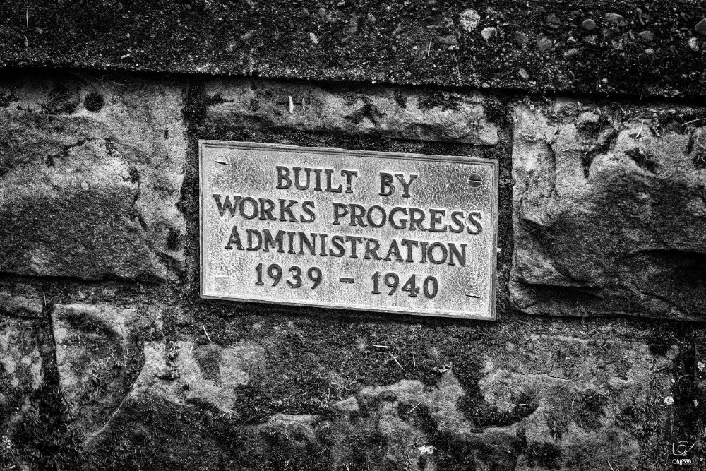 A plaque mounted on a stone wall indicates a structure was built by the Works Progress Administration between 1939 and 1940.