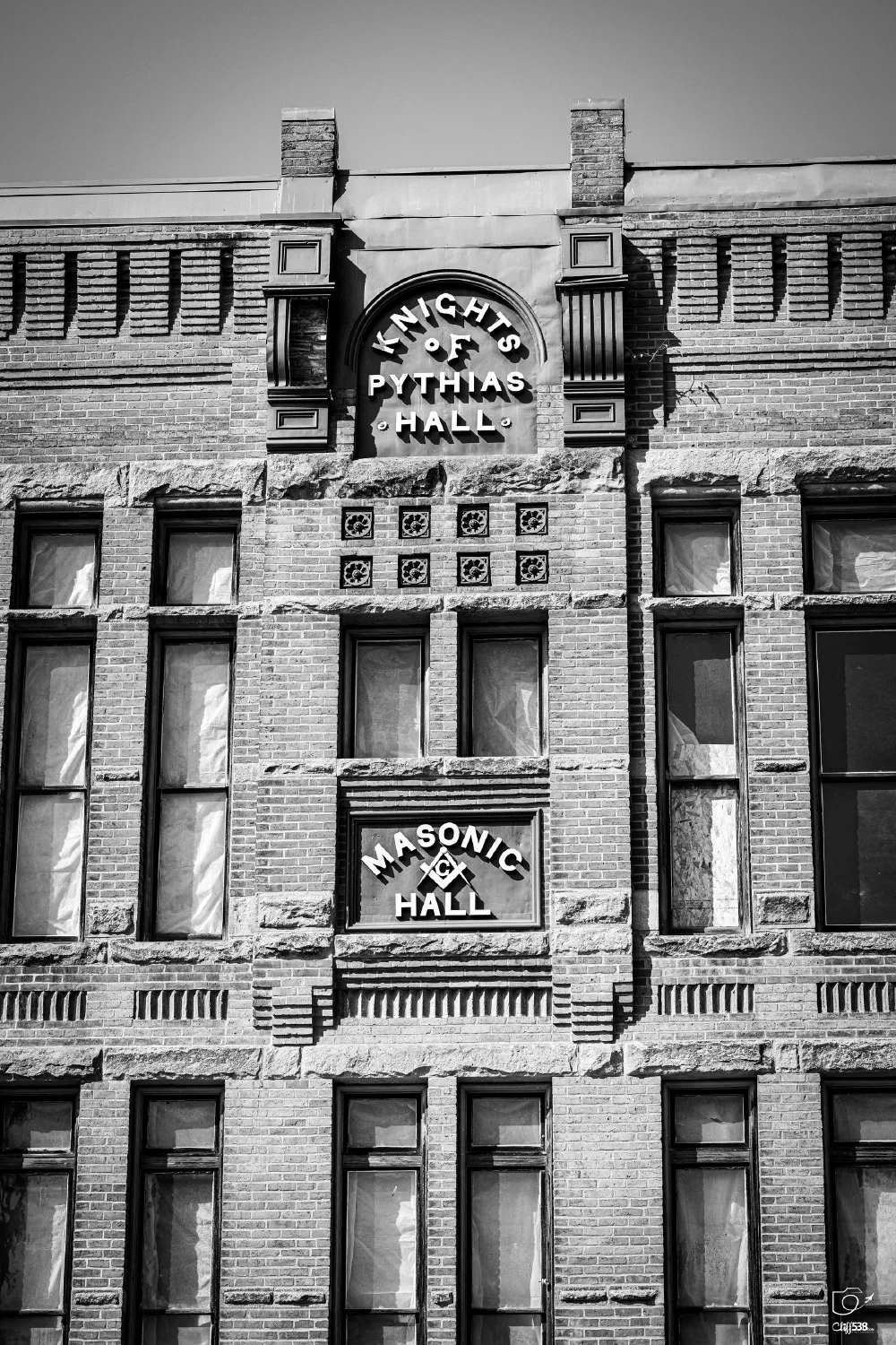 A historic brick building with signage indicating it is the Knights of Pythias Hall and Masonic Hall.