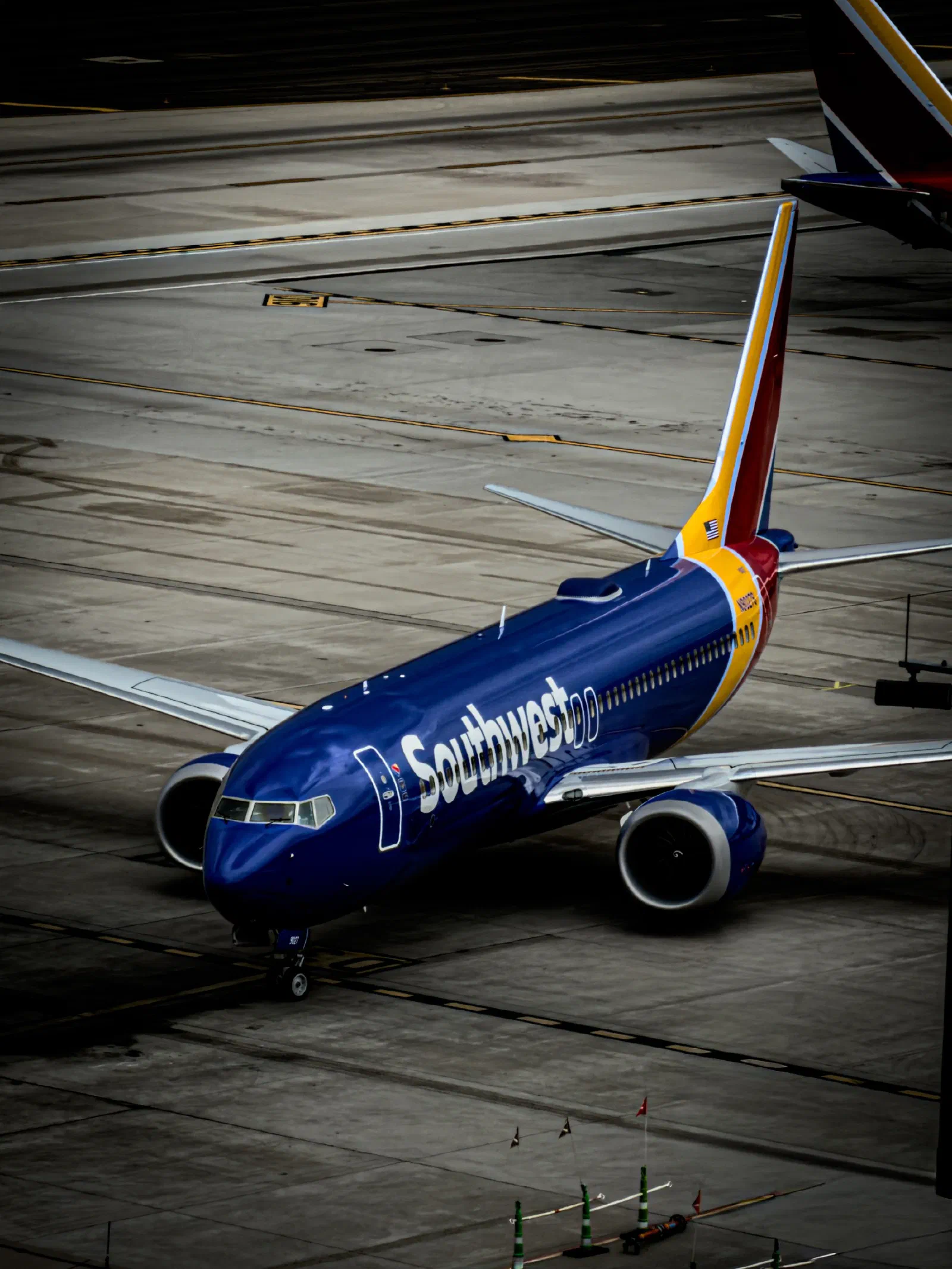 A Southwest Airlines plane is positioned on an airport tarmac, ready for departure or arrival.